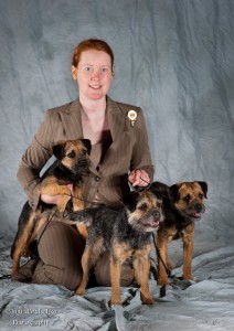 Tegan Whalan with blue border terrier bitches Myrtle, Clover, and Winnie.